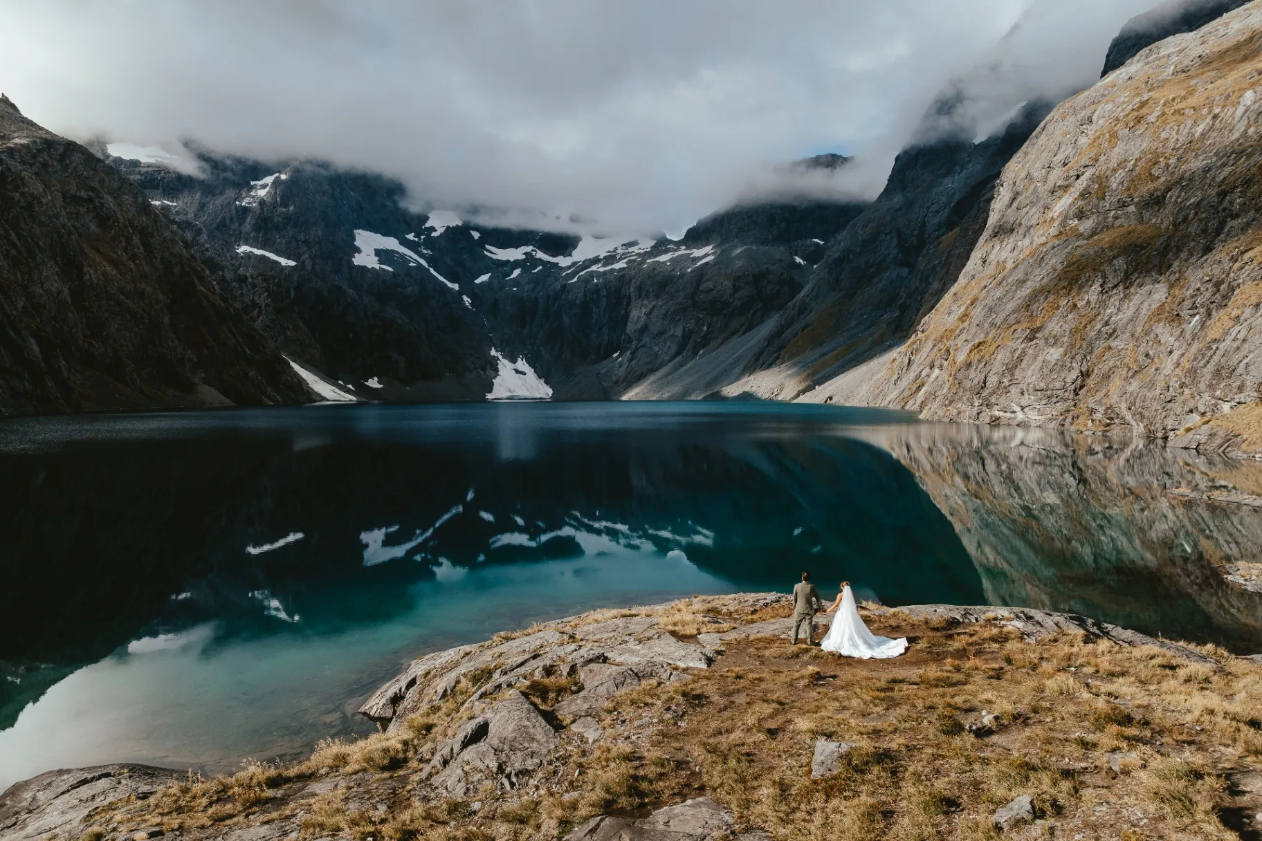 Couple beside the alpine lake at Lochnagar during a helicopter elopement