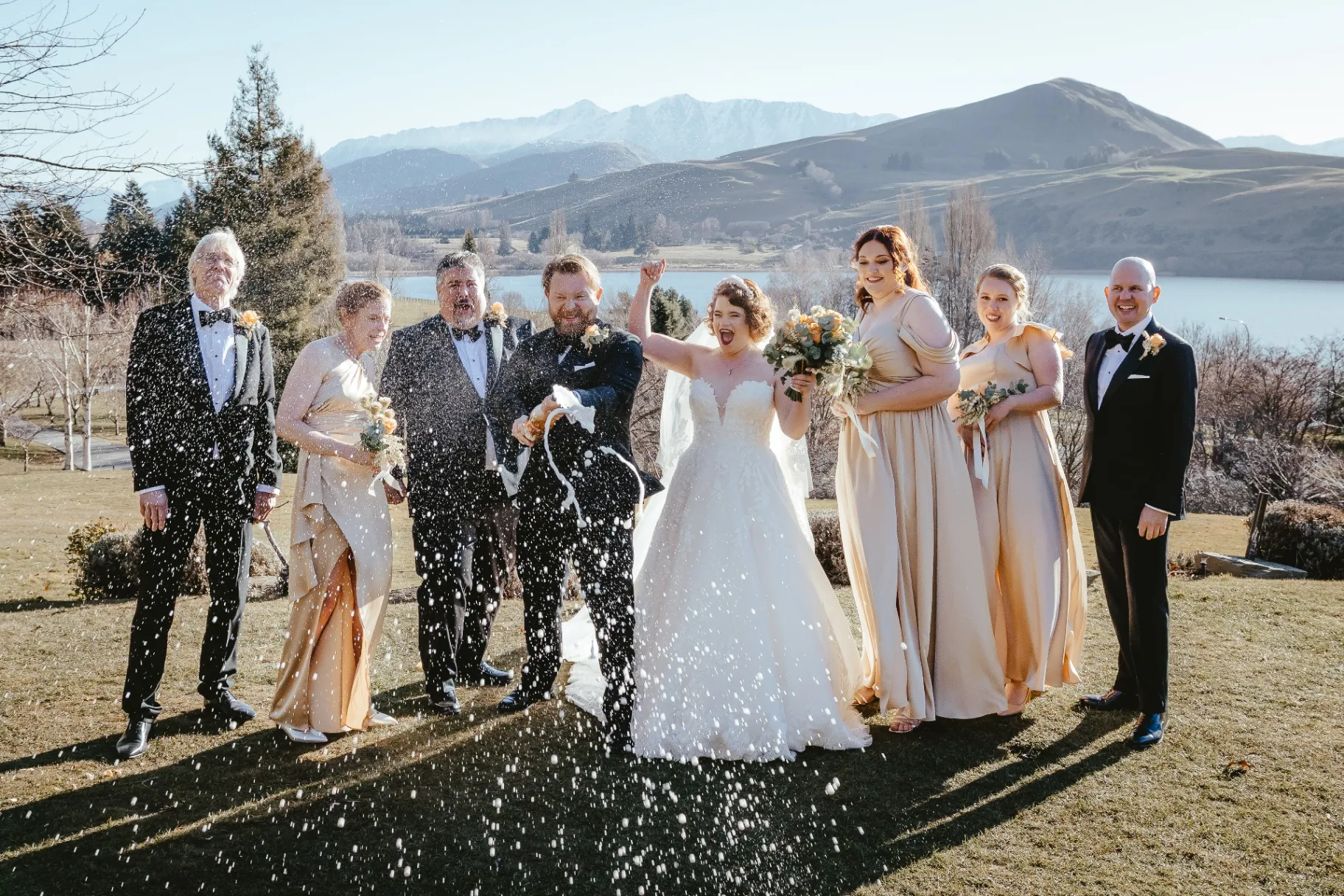 Wedding party champagne celebration beside Lake Wānaka