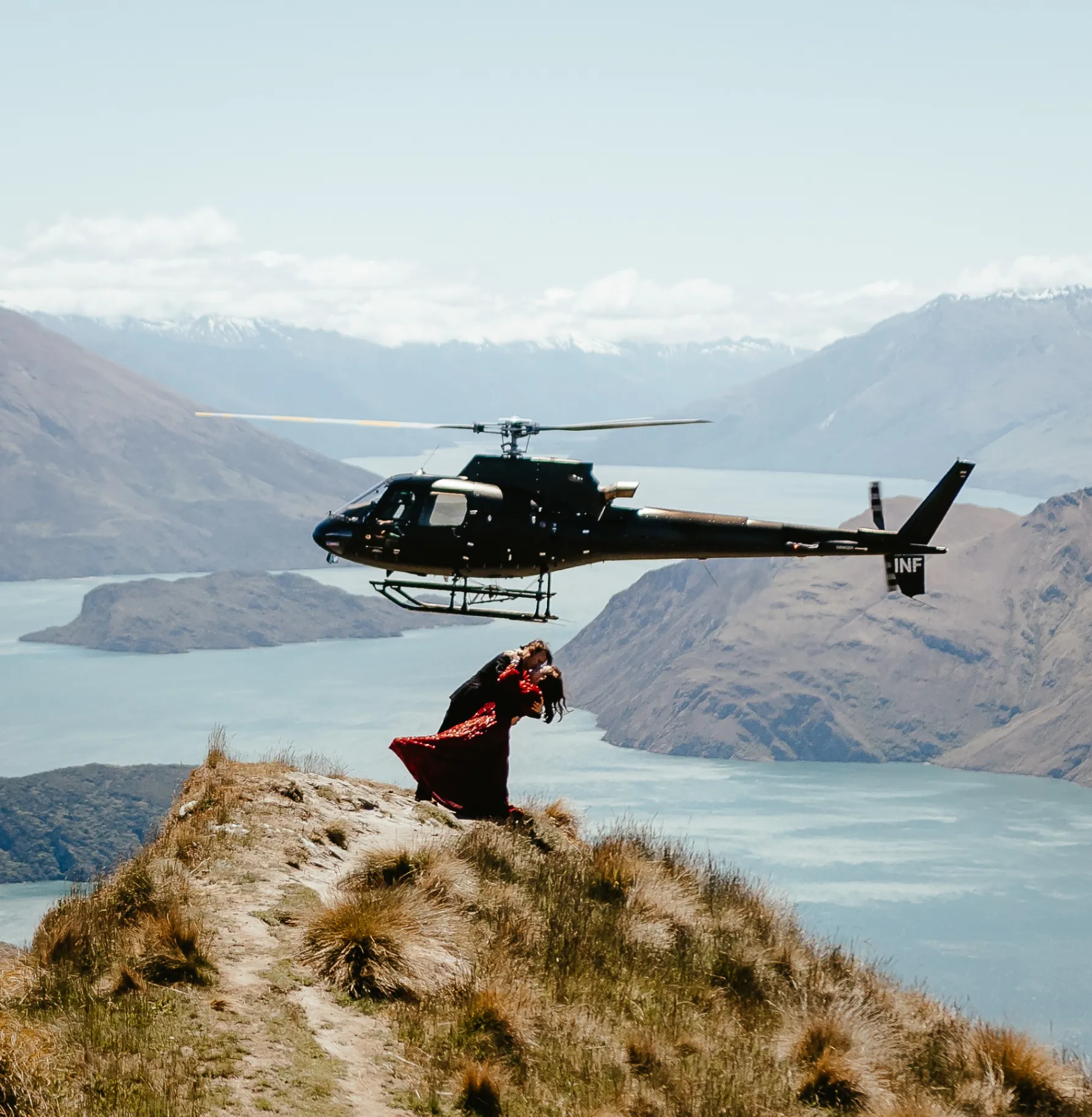 Couple kissing beside the helicopter at Coromandel Peak, Wānaka
