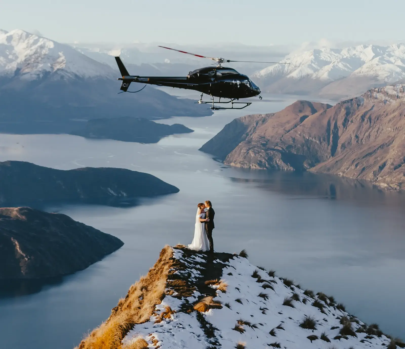 Couple beside the helicopter at Coromandel Peak during a Wānaka elopement
