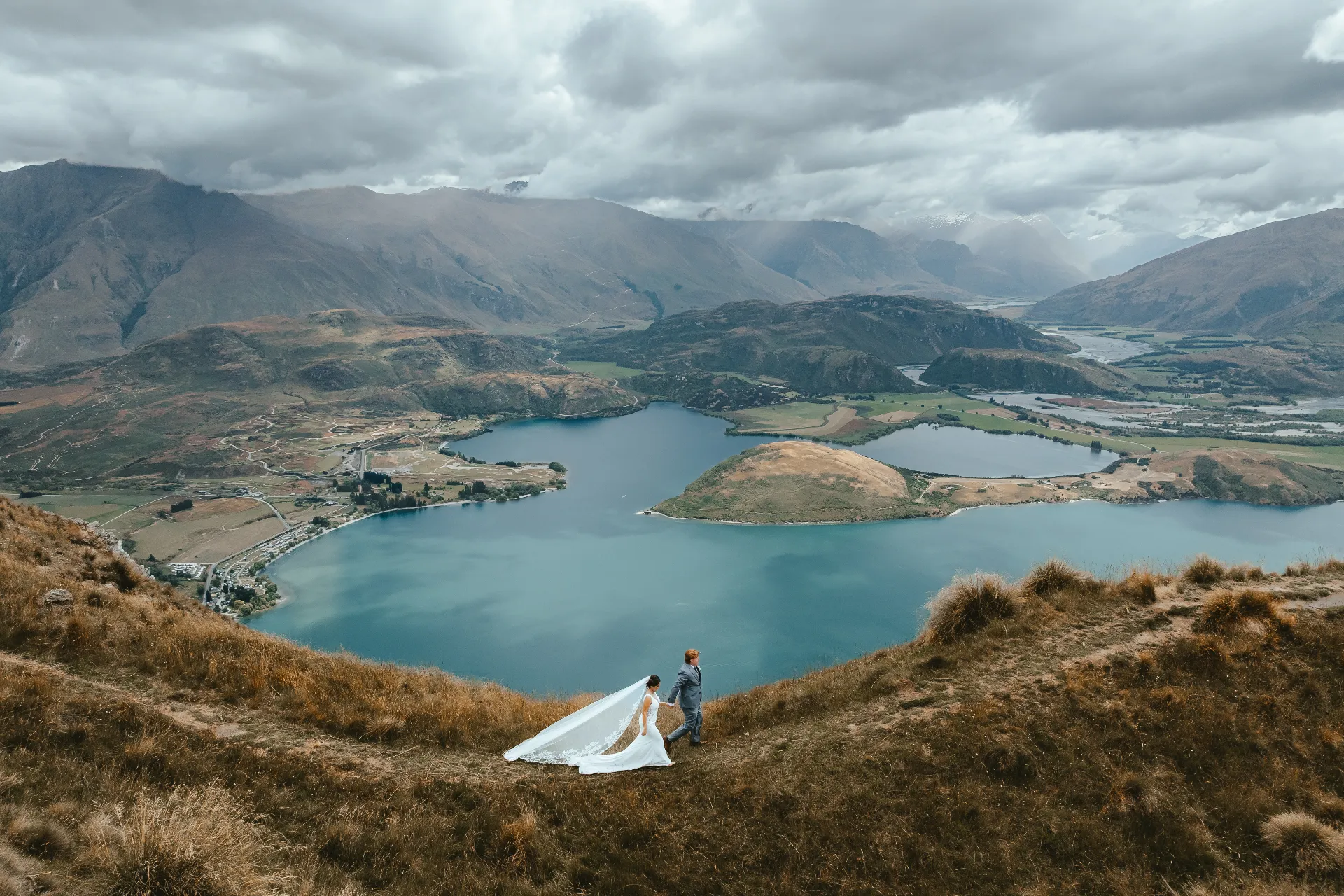 Couple walking a ridgeline above Lake Wānaka during a Wānaka elopement