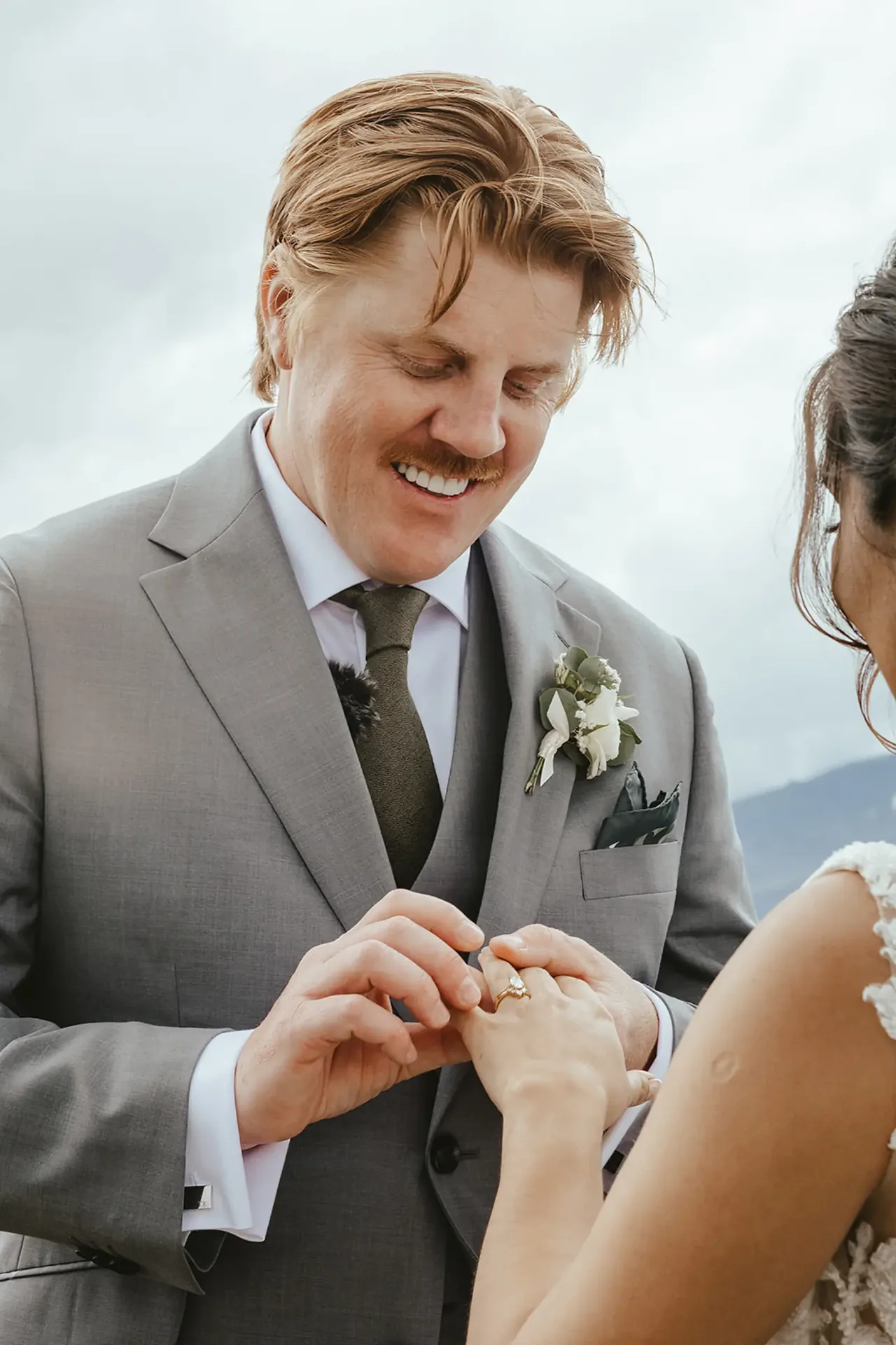 Groom placing a wedding ring on the bride's finger