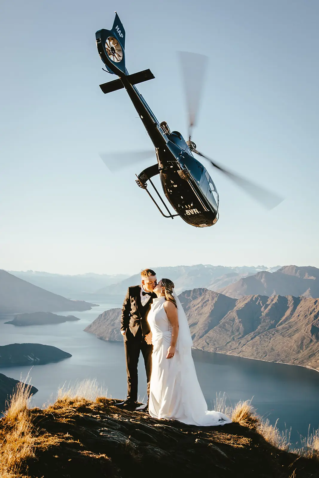 Helicopter fly-over as a couple kiss above Lake Wānaka near Roys Peak