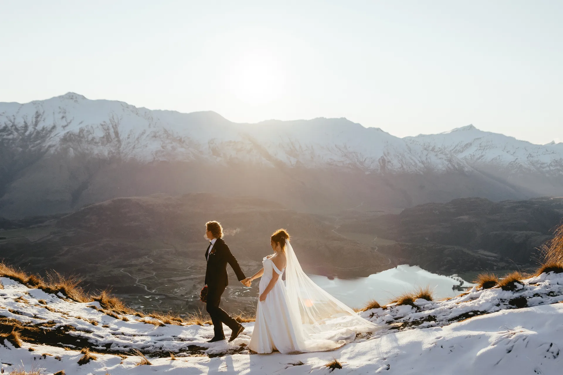 Couple walking in the Wānaka mountains at sunset