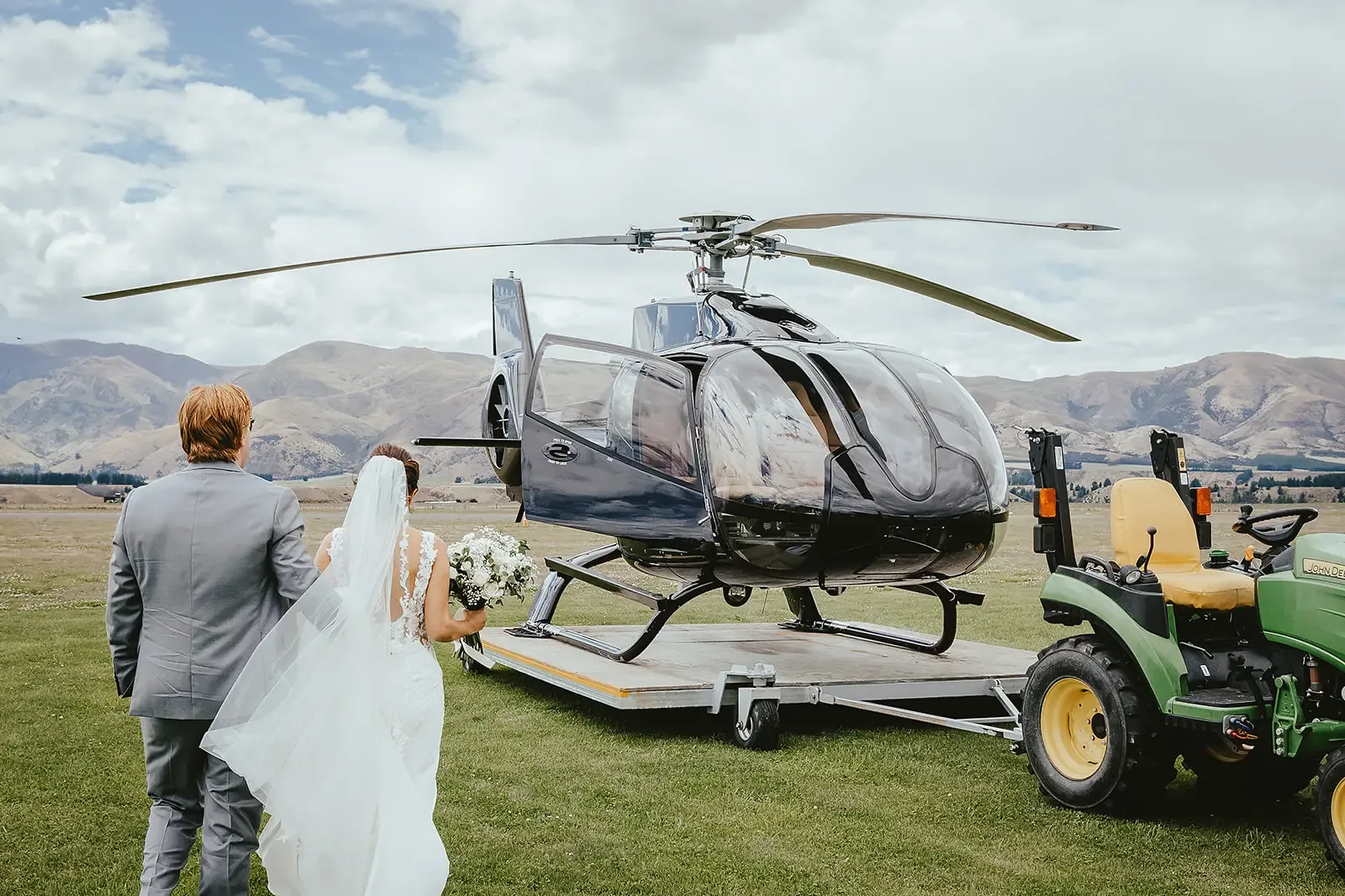 Bride and groom boarding a helicopter at the airfield