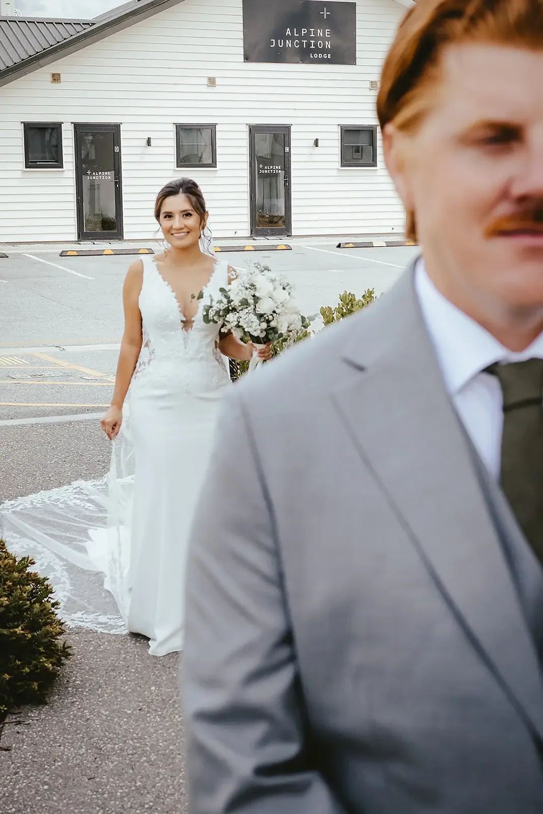 Bride walking towards the groom at a lodge first look