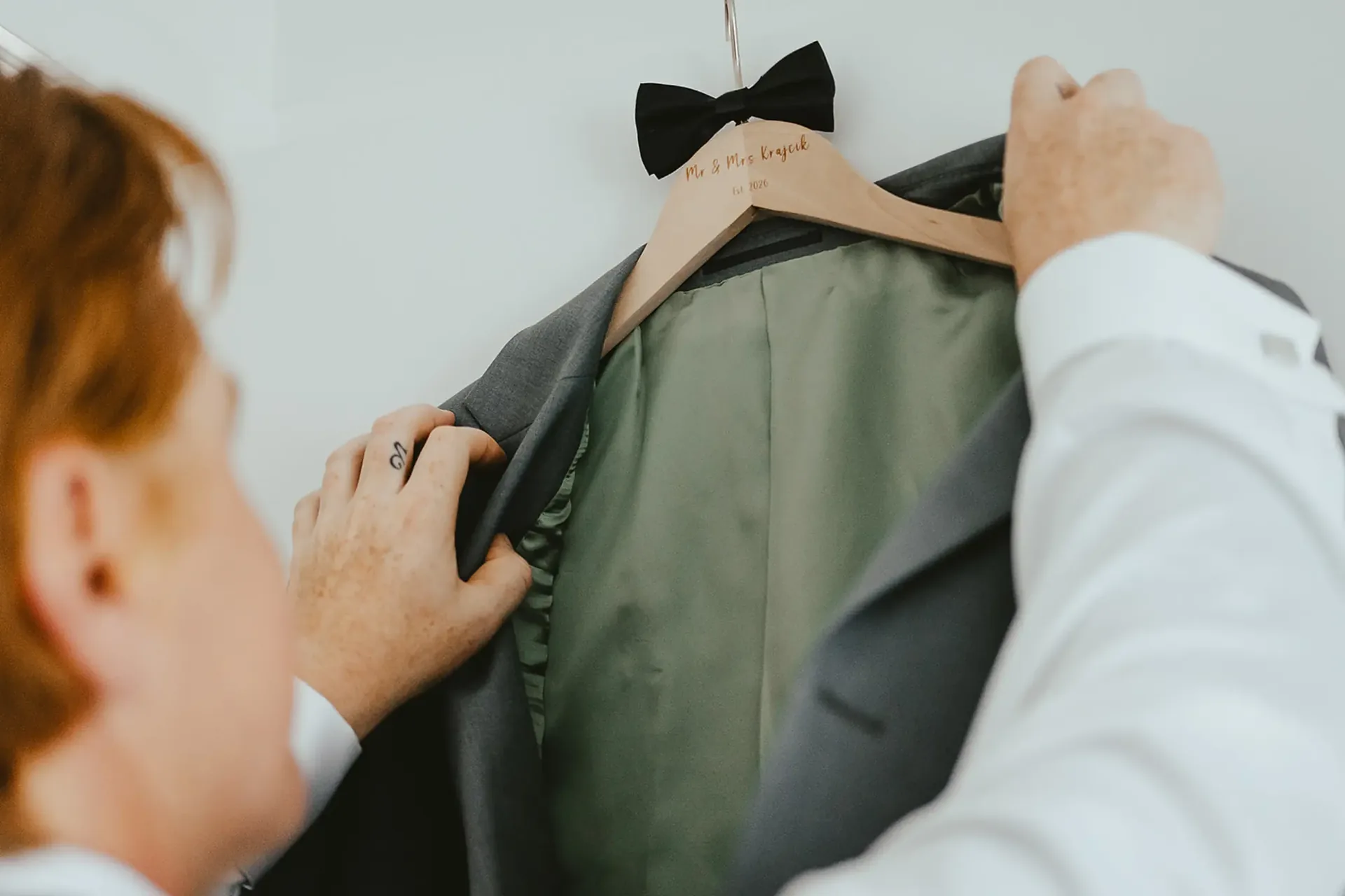 Groom's suit jacket on a custom hanger before the ceremony