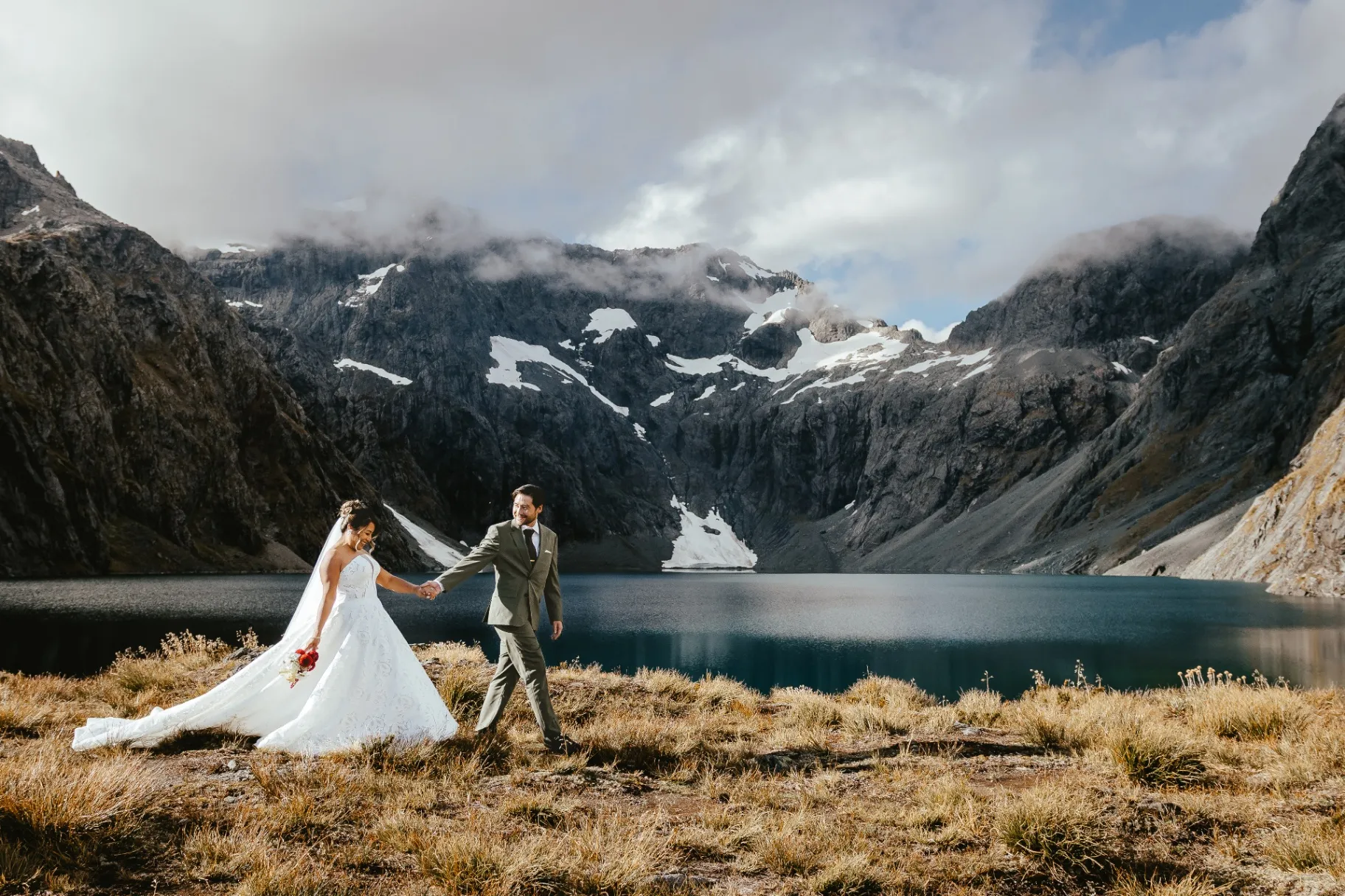 Couple walking beside the alpine lake at Lochnagar