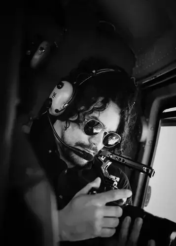 Cristian Batista in a helicopter cockpit during aerial operations