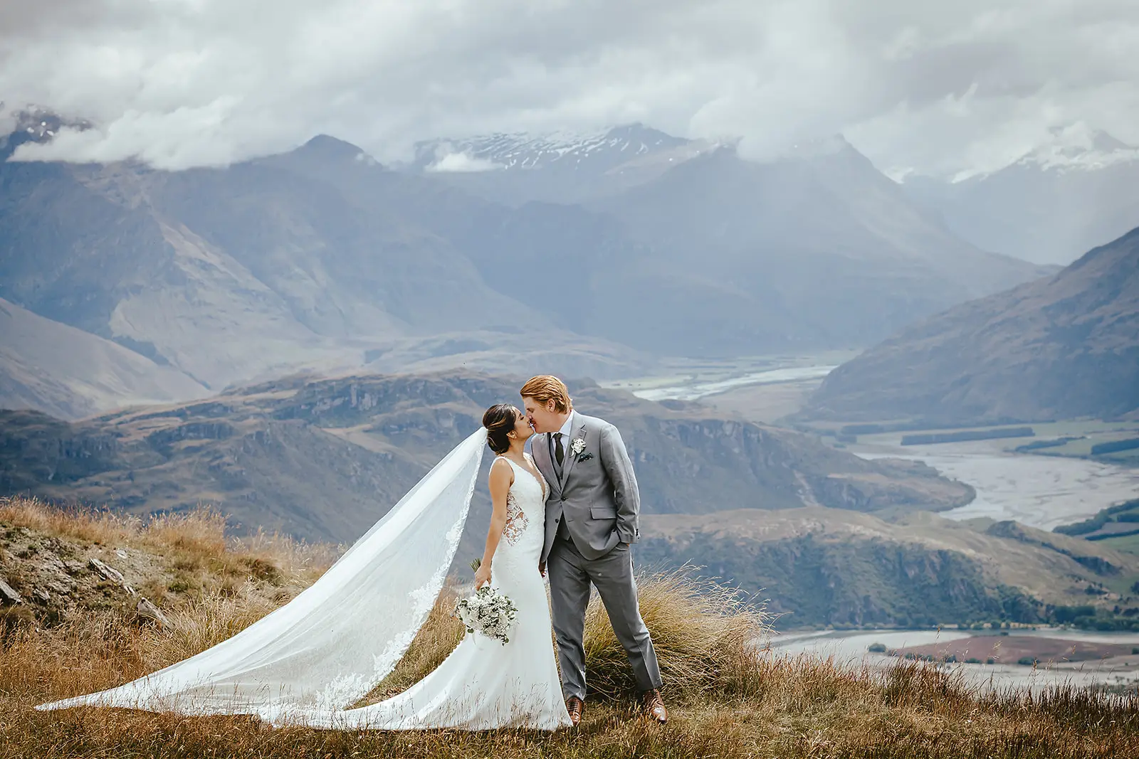 First kiss on Coromandel Peak with the veil flowing over the Wānaka valley