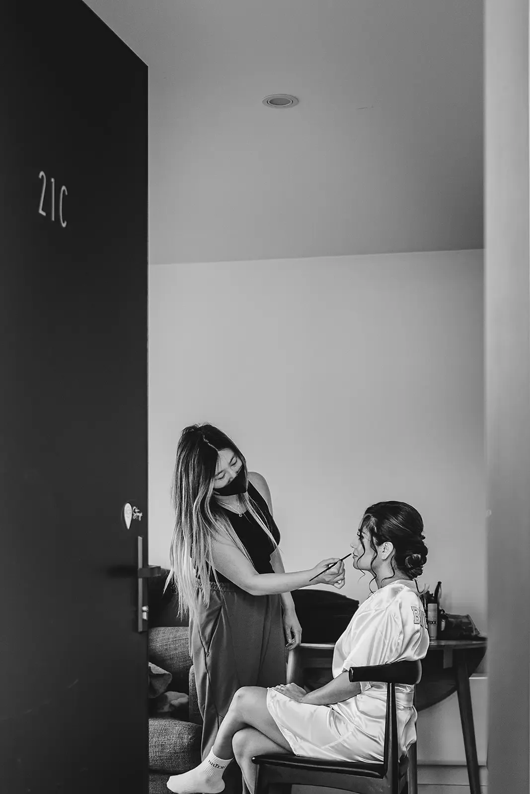 Bride having makeup done, black and white